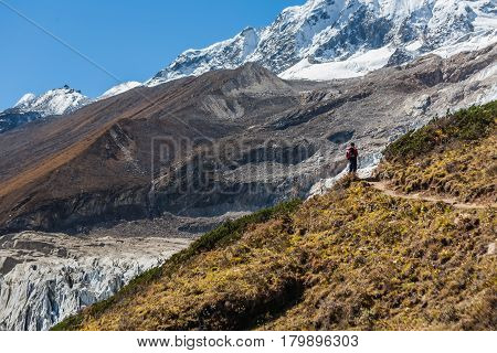 Trekker in front of Manaslu glacier on Manaslu circuit trek in Nepal
