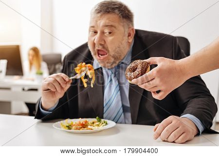 Unkind joke. Amusing will less overweight guy making attempts eating healthy food and his fellow office workers making fun of him