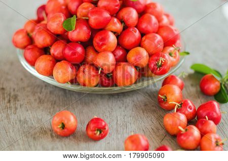 stack red and sweet cherries on wood background