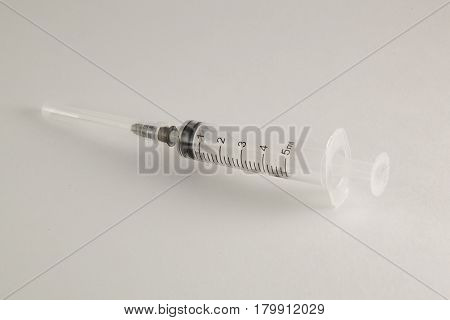 The syringe for pricks with a needle on a white background.