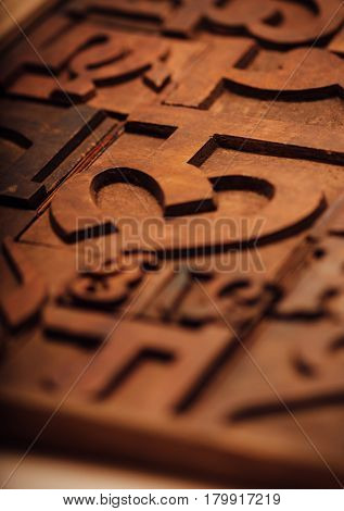 Weathered wooden alphabets of an Indian language. Traditional letter press printing blocks background.