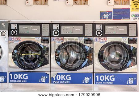 Labuan,Malaysia-Apr 3,2017:View of laundry into coin-operated washing machines at laundromats self operated laundry in Labuan,Malaysia on 3rd April 2017.