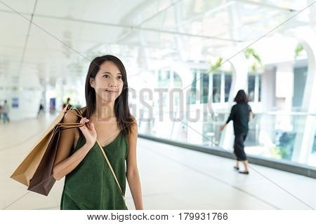 Woman holding shopping mall and walking in pedestrain foot path