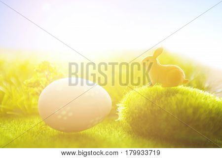 Little Easter Bunny And Easter Eggs On Green Grass Over Sunset. Macro.