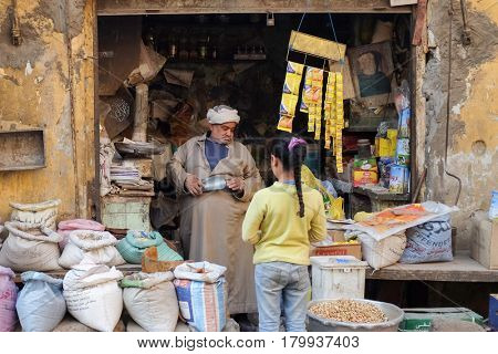 CAIRO, EGYPT - JANUARY 23, 2016: A traditional small shop and a child customer in the Capital City Cairo, Egypt.