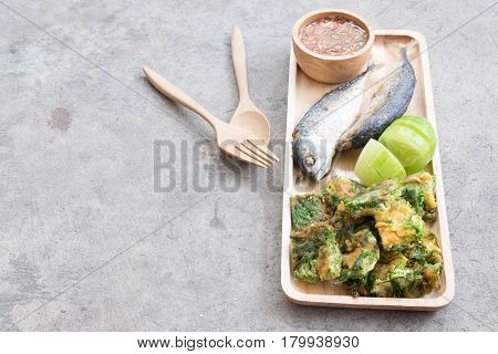Thai local popular food as spicy shrimp paste dip (Nam Prik Kapi in Thai) served with fried mackerels sliced cucumber and fried acacia pennata omelet