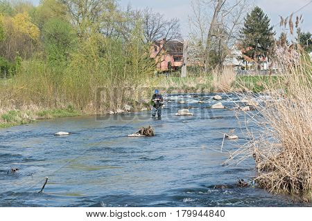 FRANKFURT, GERMANY-APRIL 04, 2017: Fly fishing in the renatured Nidda River