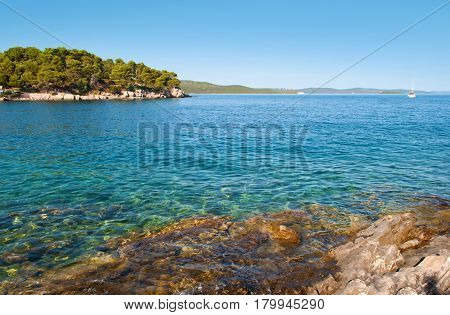 Transparent Deep Blue Sea Water And Rocky Coast