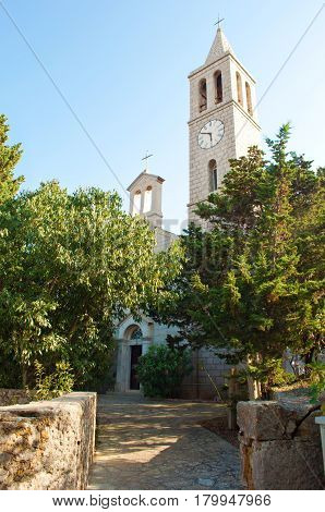 Entrance To A White Stone Church Tower