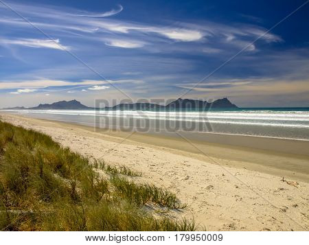 White Sand Beach With Blue Sky In New Zealand