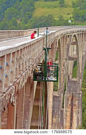 MONTENEGRO - JULY 03, 2010: Men are working on Durdevica arched Tara Bridge over green Tara Canyon. One of the world deepest Canyons and UNESCO World Heritage, Montenegro.