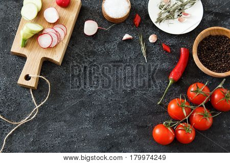 Composition of green and red vegetables on a dark background with space for text. Good for advertising posters and magazines.