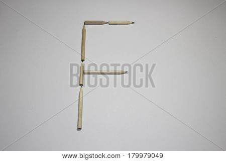 Alphabet symbol - letter F pencil on white background
