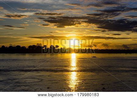 Boat on the Amazon River at sunset near Leticia Colombia