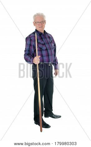A handsome senior citizen man in a checkered shirt and jeans standing with a billiard cue isolated for white background.