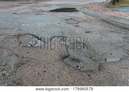 Pot Holes With Water In Road