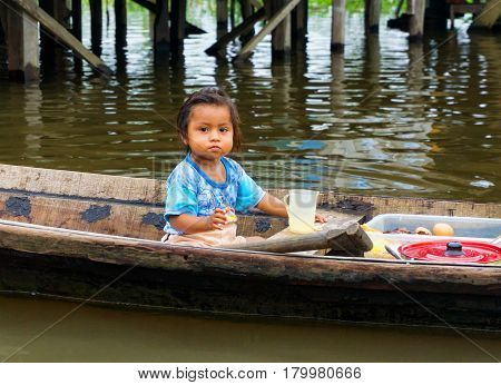 IQUITOS PERU - MARCH 17: Young girl in a canoe in Iquitos Peru on March 17 2015