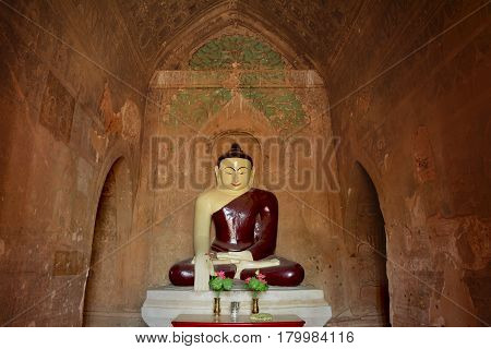 Buddha Sculpture Inside Old Pagoda With Ancient Paintings On The Walls. Bagan, Myanmar.