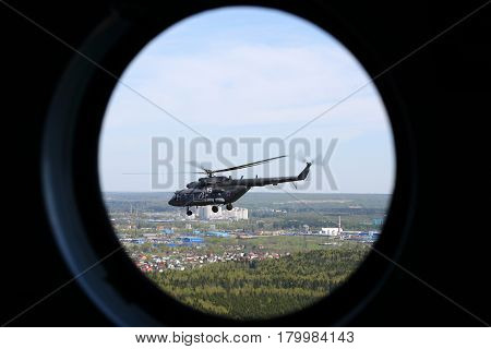 MOSCOW REGION, RUSSIA - MAY 9, 2015: Mil Mi-8AMTSH helicopter of Russian Air Force seen from window during Victory Day parade.