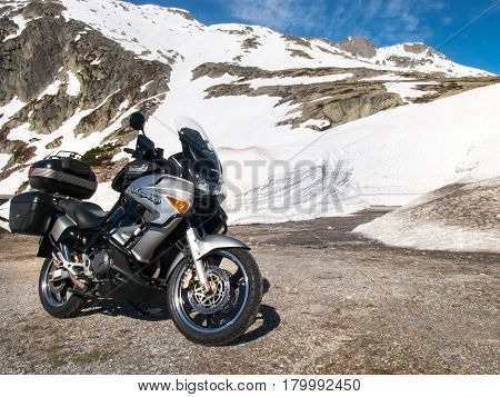Gotthardpass Switzerland - May 14 2015: Vehicles in transit between the walls of snow The pass is still a lot of snow in the winter