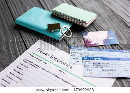 Travel preparation concept with insurance application form and credit cards for online payment on wooden table background
