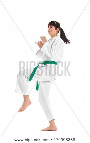 Young sporty woman practicing martial arts on white background