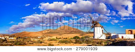 landscapes of volcanic Fuerteventura - view with traditional winndmills. Canary islands of Spain