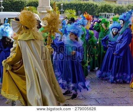 Modugno, Italy - February 4, 2018: Young People And Children With Beautiful And Colorful Clothes Dur