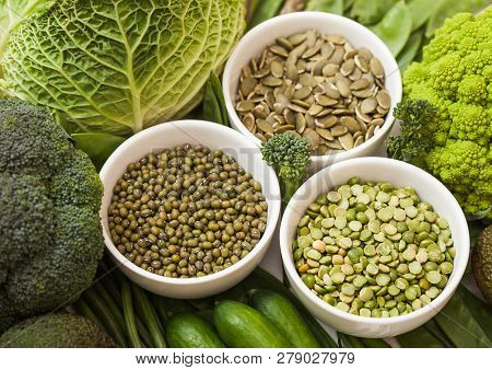 Bowl Of Mung Beans And Split Peas And Pumkin Seeds With Raw Organic Green Toned Vegetables. Macro