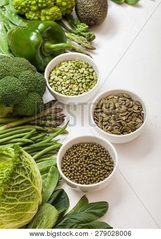 Assorted Green Toned Raw Organic Vegetables On White Background. Avocado, Cabbage, Broccoli, Caulifl