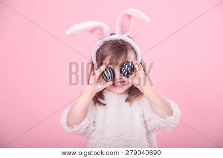 Portrait Of A Little Girl With Bunny Ears And Easter Eggs
