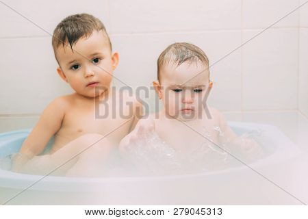 Children, Brother And Sister In The Bathroom Swimming, Playing Splashing