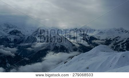 The Suns Rays Shine Through The Clouds, Illuminating The Harsh Mountains, Les Arcs, La Plagne, Parad