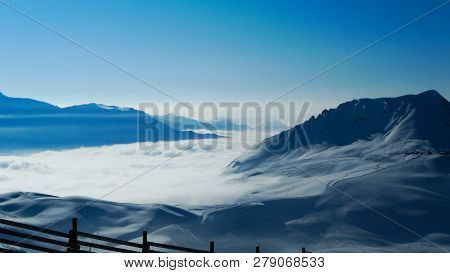 Mist Enveloped The Gorge Between The Mountains, And Above The Clouds A Clear Blue Sky, A Frosty Wint