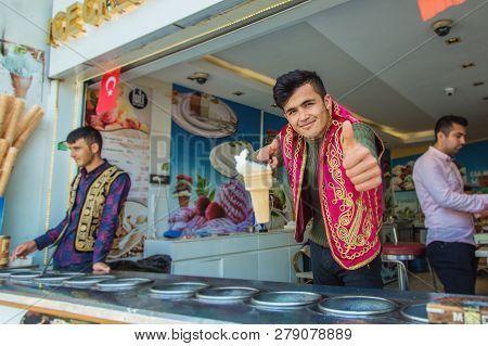 Istanbul, Turkey: Joyful Dondurma Ice-cream Seller Dressed In Traditional Turkish Costume In The Str