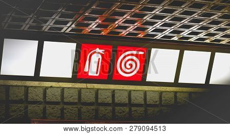 Red Sign On Bright Background Indicating Access To Extinguishers And Fire Ramps