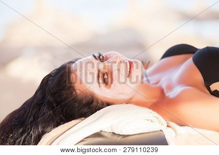 Spa Mask. Beautiful Woman Get Spa Mask On The Sunny Beach In Spa Salon Outdoor. High Quality. Scin C