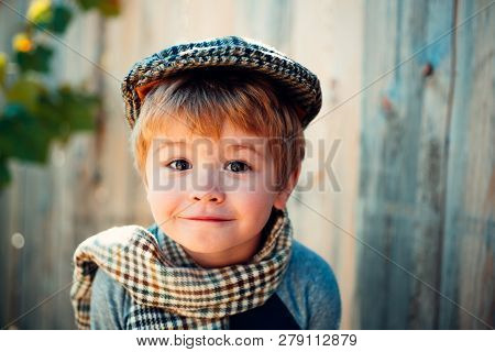 Boy. Funny Emotional Face. Child With Beautiful Eyes Looking At The Camera. Boy In A Tweed Cap And P