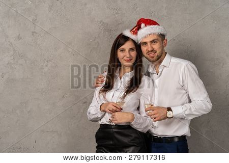 Young Business People Holging Glasses Of Champagne And Looking At Camera
