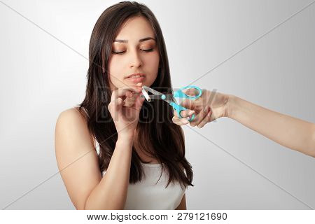 Stop Smoking Concept. Young Woman Cut Cigarettes With Scissors Happy Smiling. Focus On Hand, Scissor