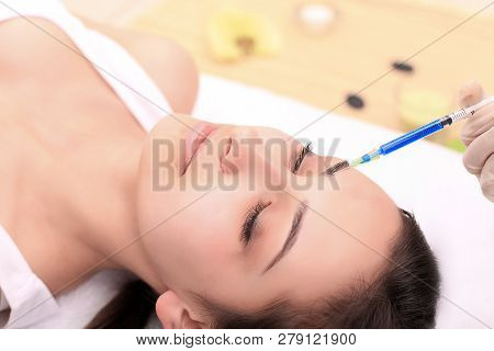 Woman Gets Injection In Her Face. Beauty Woman Giving Injections. Young Woman Gets Beauty Facial Inj