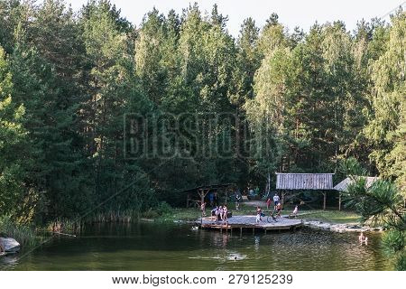 Korostyshiv, Ukraine - August 15, 2017: People Have Rest And Swim On The Lake In The Middle Of A Con