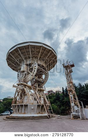 Old Rusty Abandoned Radio Telescope Satellite Dish.
