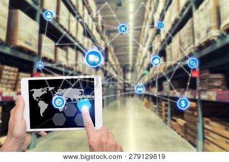 Laptop With White Blank Screen With Global Map On Brown Wooden Desk And Blurred Warehouse Store Back