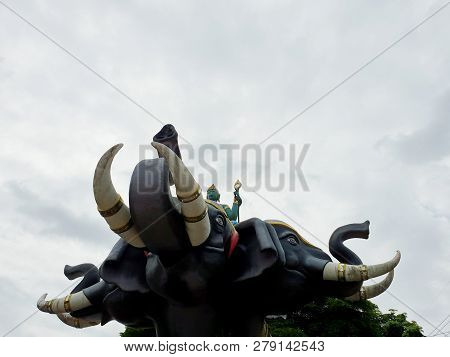 Looking Up Of Indra The God Of Hindu On Elephant On Blue Sky As A Background In Temple At Thailand, 