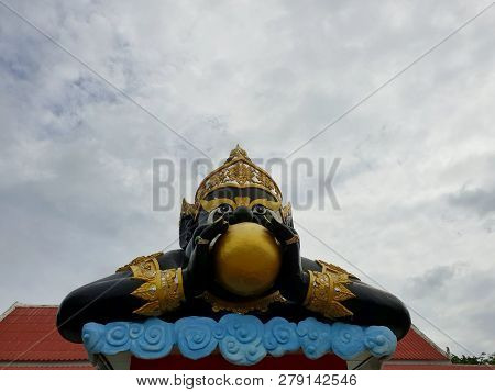 Looking Up Of Big Phra Rahu On Blue Sky As A Background In Temple At Thailand, The Statue Pose Is Th