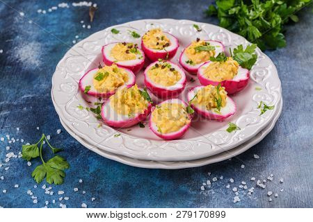 Beet-dyed Deviled Eggs. Easter Stuffed Eggs On Blue Background. Copy Space