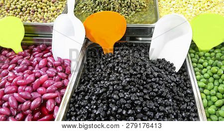 Tray Filled With Black And Green Olives And Other Organic Products Such As Red Onions For Sale In Th