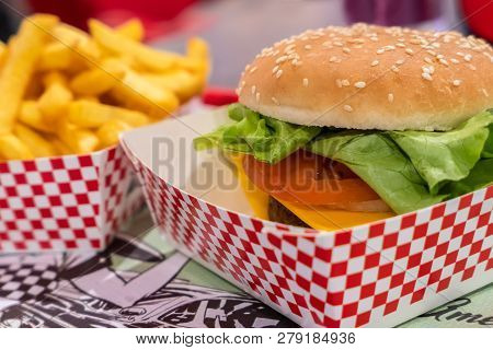 Prepared Vegan Seitan Burger Meal. On Defocused Blurry Background The Chips Fries. Ideal For Concept