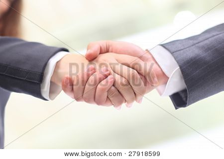 High angle view of business woman and man shaking hands